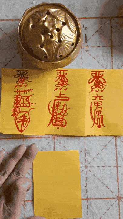Taoist priest is drawing talismans