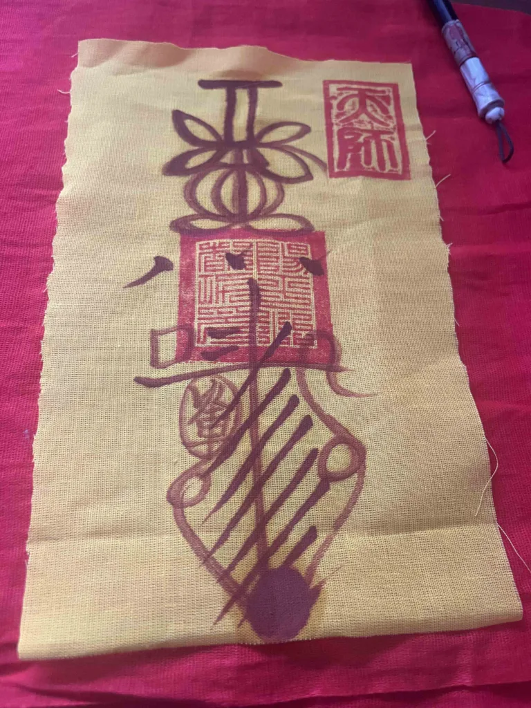A completed talisman on fabric.