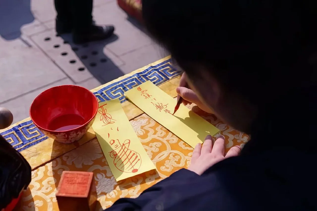 A Taoist priest is drawing talismans.